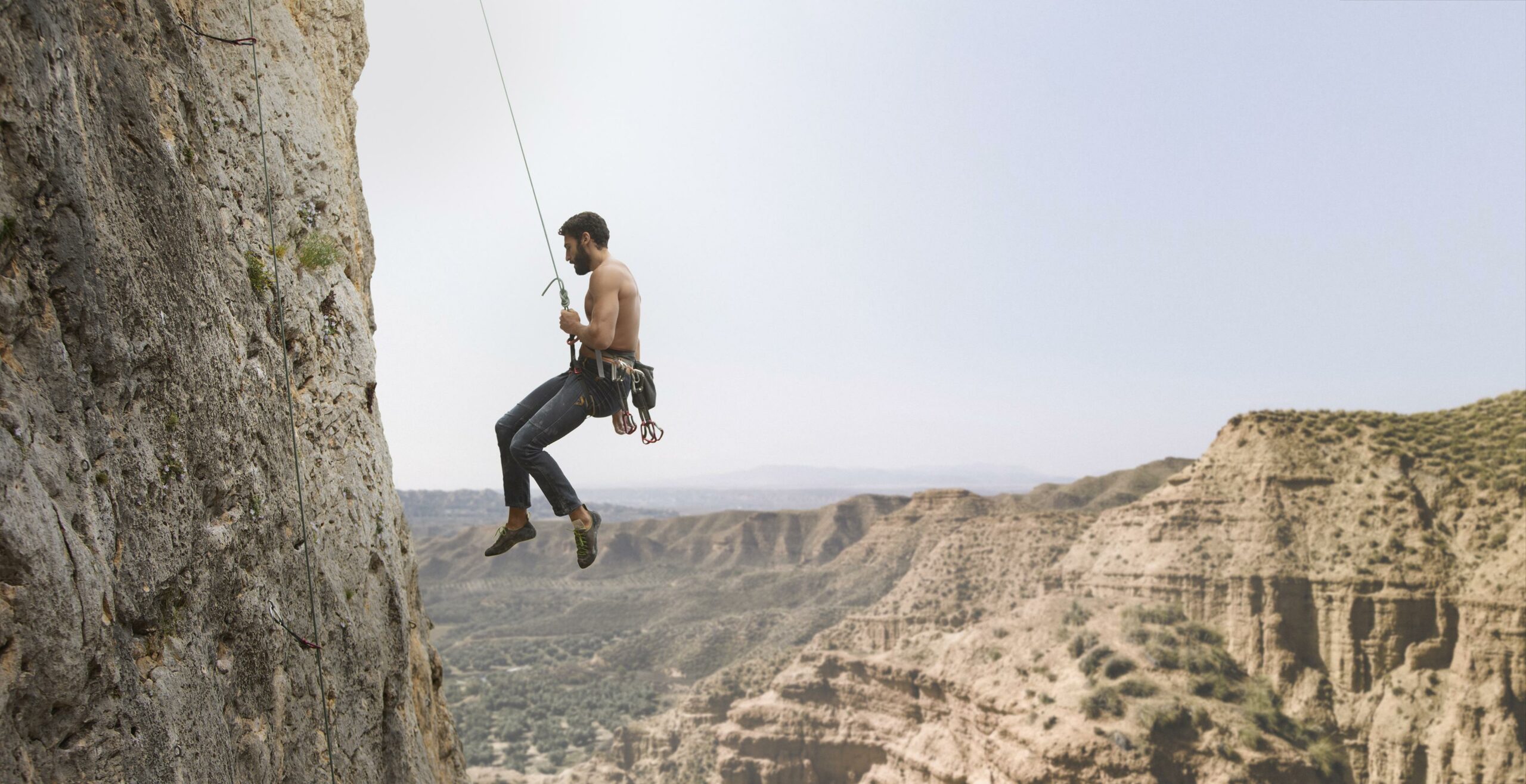 A climber rappelling with a single rope, highlighting the simplicity and lightweight benefits of this technique.
