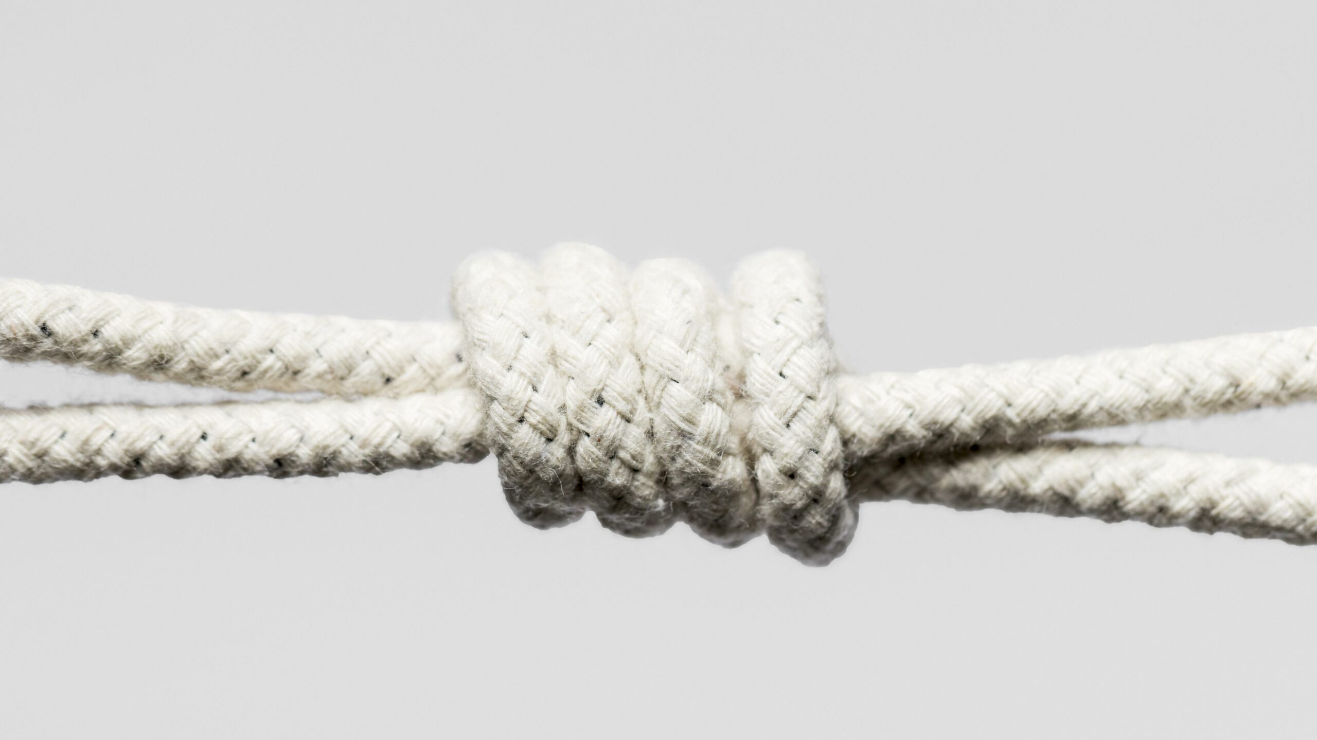 A close-up photo of a rope with a properly tied figure-eight knot for rappelling