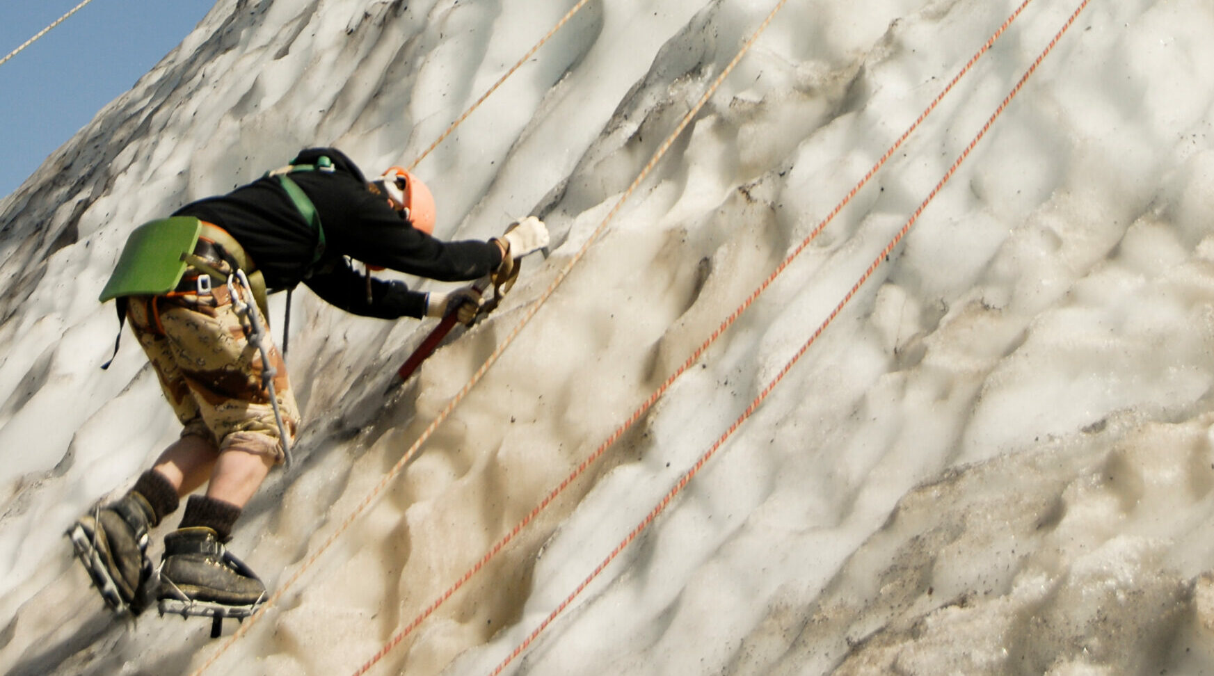 A climber tying a figure-eight knot, an essential skill for safe rappelling.